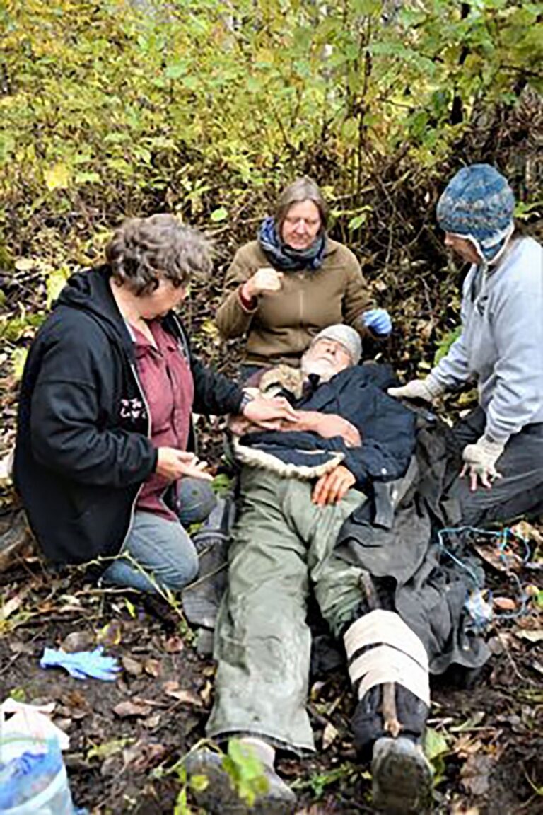 Chapter members practicing wilderness first aid on a volunteer