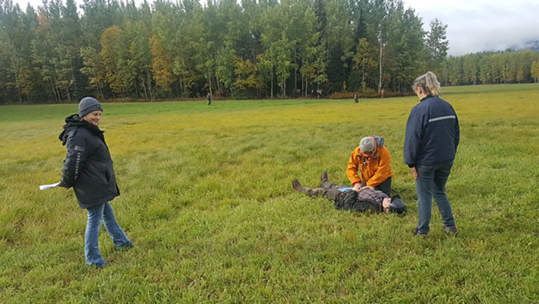 Chapter members at a clinic in a large grassy field
