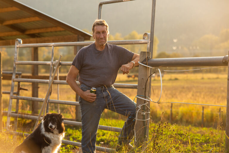 West Kootenay Chapter member with a dog beside a corral