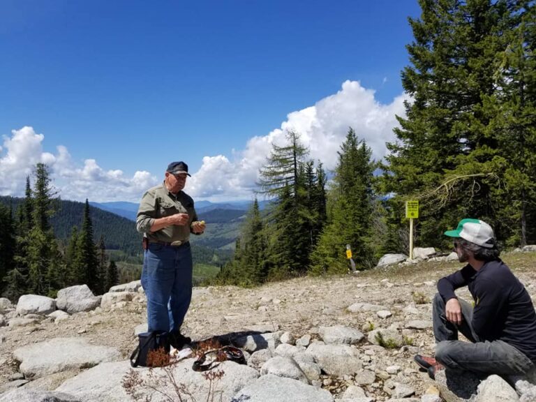 Riders resting on a rocky mountain ridge