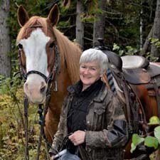 Verna Houghtaling, BCHBC Membership Coordinator, with a horse on the trail