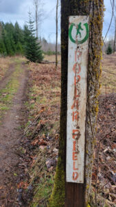 Log Train Trail marker post beside the trail in the Alberni Valley