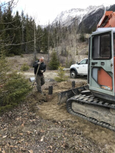Excavator and volunteers preparing the Moose River staging area
