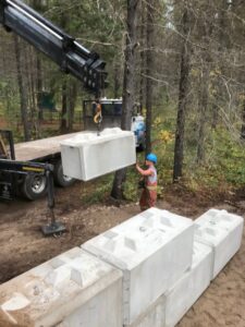 Concrete blocks being set for a manure bin at Trapping Creek camp